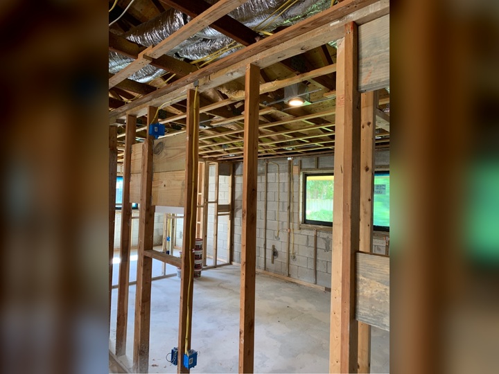 Electrician running conduit and wiring during a commercial tenant improvement project in Miami